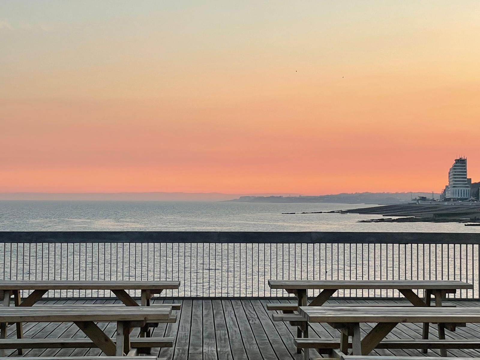 Sunset over the sea from the Hastings seafront terrace