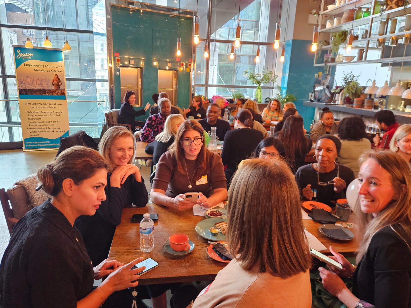 Women networking around a table at a Supermums community meet-up